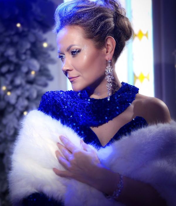 A woman in athletic wear smiling during a light cardio workout in a modern studio.